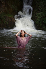 a girl bathes in a river, a girl bathes in a waterfall