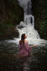 a girl bathes in a river, a girl bathes in a waterfall