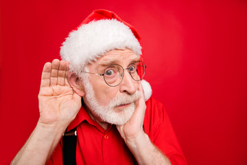 Close-up portrait of his he nice stunned amazed curious suspicious bearded Santa Claus trying to...