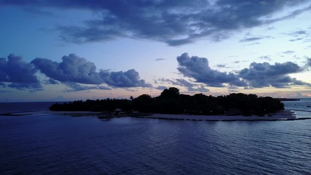Silhouette of the tropical island on purple blue sunset. Aerial drone panoramic shot