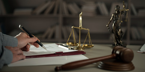  A lawyer working at a desk in a courtroom