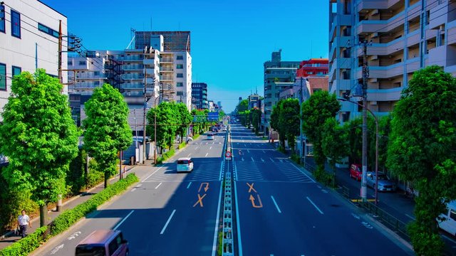 A timelapse of downtown street at Kanpachi avenue in Tokyo daytime wide shot tilt