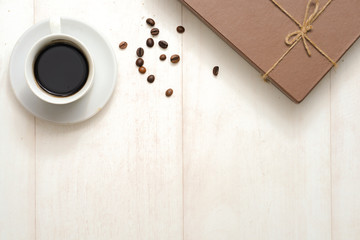 Autumn composition. Gift or Present box with empty card, autumn leaves and flower on brown rustic wooden background. Flat lay, top view, copy space