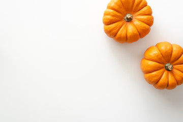Mini pumpkins lay on white background.