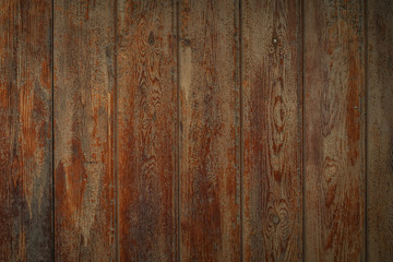 Dark brown wooden boards with a worn surface. Old wooden background texture with vertical pattern.