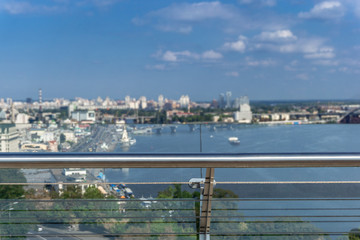 Fototapeta na wymiar VBlurred vew on River Dnepr, bridge and city center of Kiev, Ukraine on a sunny day