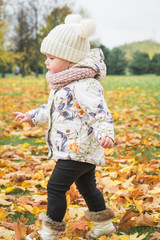 Happy little girl in autumn park