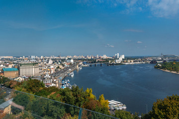 Fototapeta premium Panoramic view city center of Kiev, river Dnipro and bridge near the Arch of Friendship of Peoples from the glass bridge