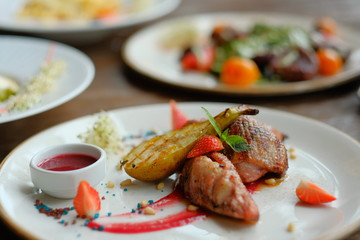 Delicious dish with pear, strawberries sauce.