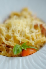 Spaghetti, with basil, mozzarella cheese. closeup