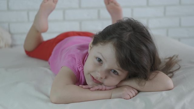 Child in pajamas lay in the bed.