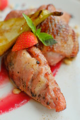 Delicious dish with pear, strawberries sauce.