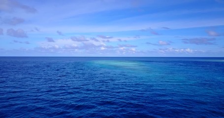 astonishing horizon view, endless open ocean meeting the beautiful blue sky with fantastic cloud formation, aerial drone background shot with copy space