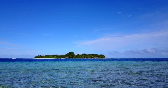 distant view of Prison Changu Island, in crystal clear water of Zanzibar archipelago, Indian ocean, Tanzania, static wide background shot with copy space