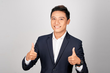 Asian smiling businessman showing thumb up both hand, isolated on white background