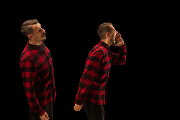 Young handsome man arguing with himself on black studio background. Concept of human emotions,...