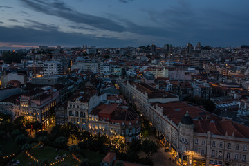 Obraz premium Cityscape of evening Porto, Portugal with the roofs in old town during sunset. Shot from bell tower of Church of the Clergymen at sunset with a beautiful sky