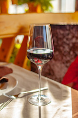 a glass of red wine on the table in the restaurant
