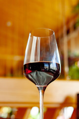a glass of red wine on the table in the restaurant