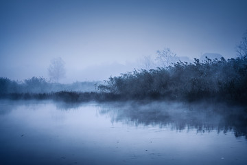 Fototapeta premium Fog over the river on a cold autumn morning