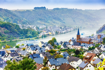 Fototapeta premium Germany, Europe. Traditional Panorama of Moselle river valley, view of towns Alken and Kattenes. Nearby Thurant Castle on hill top. Picturesque seasonal autumnal landscape of German countryside.