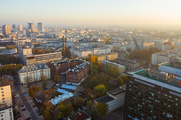 Fototapeta na wymiar Aerial view of a beautiful cityscape with skyscrapers and buildings at sunrise. Warsaw Poland. 16. October. 2019. Drone flies of a beautiful cityscape with skyscrapers at sunrise. 