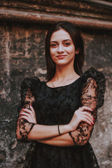 Black-haired girl. Black lace dress. Model shooting. Fashion and style.