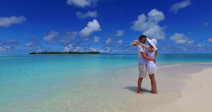 Couple Hugging on this beautiful tropical beach in the Maldives