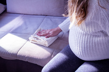 Sitting pregnant woman learns to fold a diaper for the baby. Cloth diaper. Friendly to nature. The...