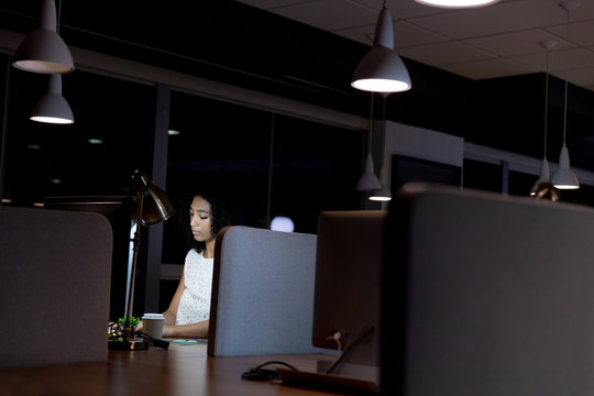 Young female professional working late in creative office 