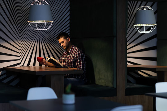 Young male professional working late in creative office