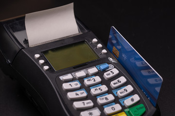 POS terminal, Payment Machine with credit card on black background.