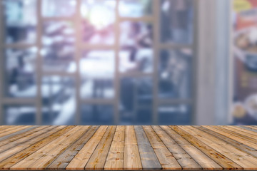 Wooden table with blur restaurant background