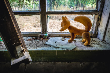 Plastic fox on a window of desolate cottage in Mashevo, small village located in Chernobyl exclusion area, Ukraine