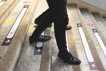businessman legs walking down the stairs