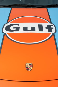 Closeup of a Porsche 911 race car badge in classic Gulf Racing livery in Blackbushe, UK - December 28, 2016 
