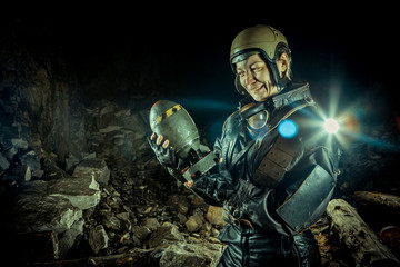Fototapeta premium Soldier woman with the bomb on post apocalyptic background.