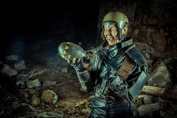 Fototapeta premium Soldier woman with the bomb on post apocalyptic background.