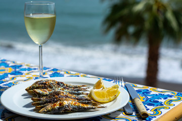 Espeto, Malaga style fish on stick barbecue prepared on olive tree firewoods and white wine