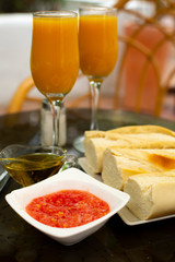 Traditional andalusian breakfast with freshly squeezed orange juice, bread toasts, fresh ground tomatoes and olive oil