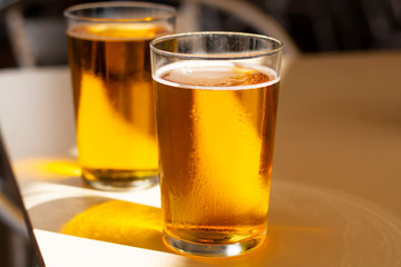 Cold amber color light spanish beer served in glass in outdoor cafe in sunny Andalusia, Spain