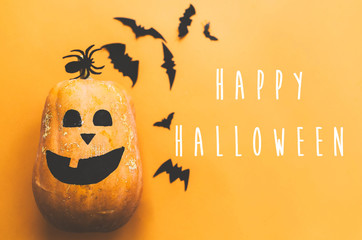 Happy Halloween text, greeting card. Pumpkin with face and black bats, ghost, spider paper...