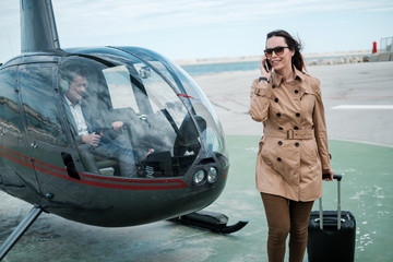 Business woman near private a helicopter