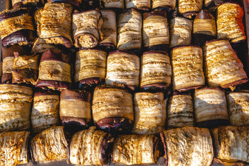 Top view vegetable rolls made of zucchini, grilled eggplant, neatly placed on a spacing, festival food, snacks. food court. texture