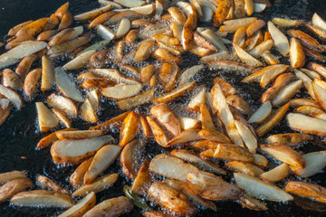 Top view of Roast potatoes in a large pan. Delicious food at the festival. Field kitchen at the hearth. lovely delicious and appetizing, yummy, background texture