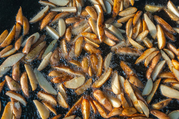 Top view of Roast potatoes in a large pan. Delicious food at the festival. Field kitchen at the hearth. lovely delicious and appetizing, yummy, background texture