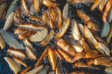 Top view of Roast potatoes in a large pan. Delicious food at the festival. Field kitchen at the hearth. lovely delicious and appetizing, yummy, background texture