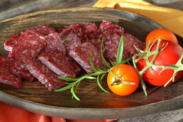 Flat dry salami or sausages. Gourmet meat. Delicacy salami.