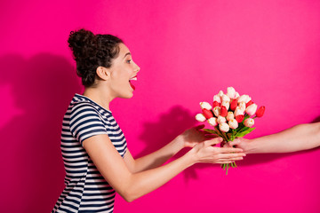 Profile side photo of astonished girl at copyspace receive bunch tulips present for 8-march 14-february scream wow feel impressed it was unexpected wear trendy clothes isolated pink color background