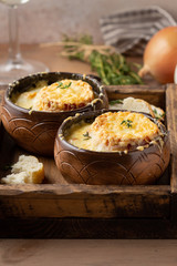 Traditional French onion soup, with croutons, Gruyere cheese, thyme. Tasty cozy, hot, autumn food